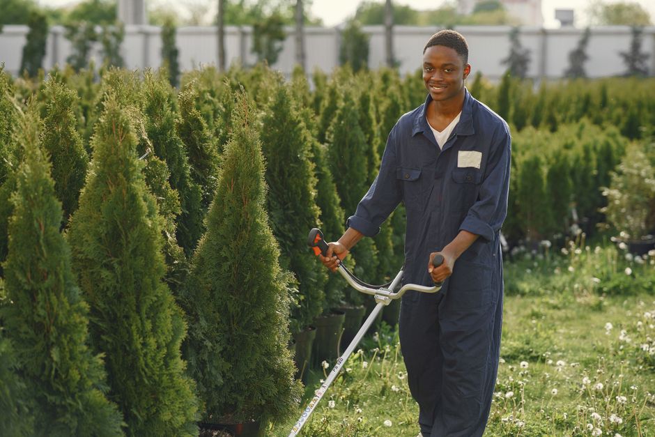 Smiling landscaper working in a lush garden